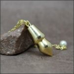 Petit pendule métal doré