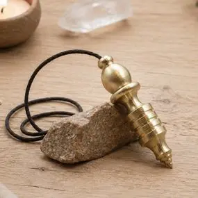 pendule émetteur osiris en laiton sur fond bois